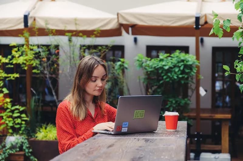 Freelancer working on a laptop in a cafe